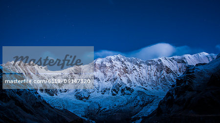 Clouds and stars at night over Annapurna, image taken from Base Camp in the Sanctuary, Himalayas, Nepal, Asia