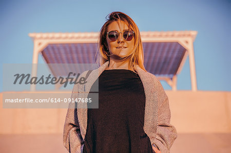 Portrait of woman wearing sunglasses looking at camera smiling