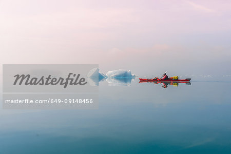 Man sea kayaking in fjord, Narsaq, Kitaa, Greenland