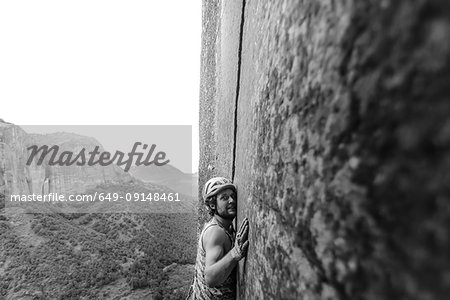 Rock climber climbing sandstone rock, Liming, Yunnan Province, China