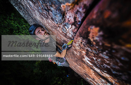 Rock climber climbing sandstone rock, elevated view, Liming, Yunnan Province, China