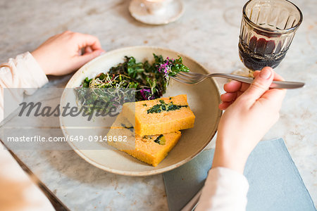 Woman having vegan meal in restaurant