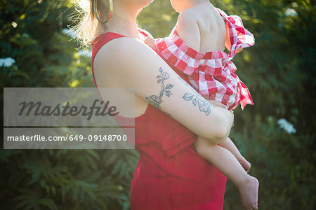 Woman and baby girl in garden