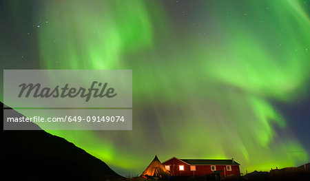 Landscape with log cabin and aurora borealis at night, Narsaq, Vestgronland, South Greenland