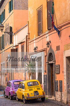 Two vintage Fiat 500s with Roma number plates parked in colourful backstreet of Trastevere, Lazio, Italy, Europe