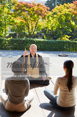 Japanese priest preaching to women at a temple