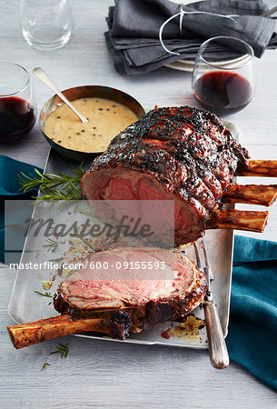 Standing rib roast with bearnaise sauce and glasses of red wine