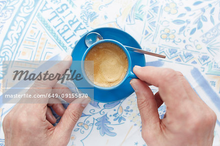 Cropped overhead view of woman with espresso