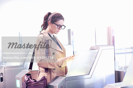 Businesswoman walking through security gate at airport