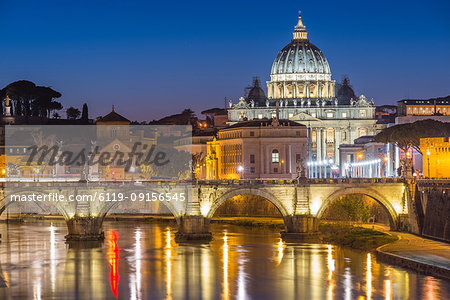 Illuminated St. Peters Basilica and the Vatican with Ponte St Angelo over the River Tiber at dusk, Rome, Lazio, Italy, Europe