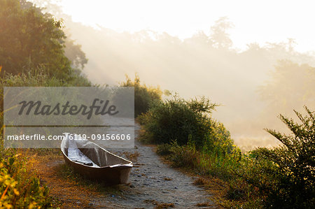 Canoe on a riverbank at dawn, Chitwan National Park, UNESCO World Heritage Site, Nepal, Asia Canoe on a riverbank at dawn, Chitwan National Park, UNESCO World Heritage Site, Nepal, Asia