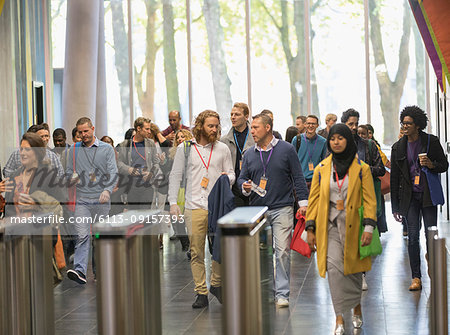 Business people arriving at conference, walking in lobby