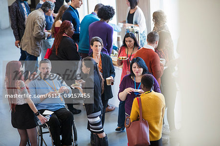 Business people networking, talking at conference