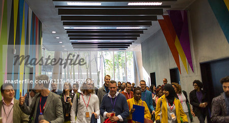 Business people arriving, walking in office lobby