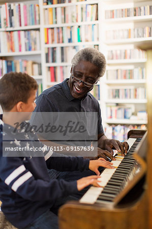 Grandfather and grandson playing piano