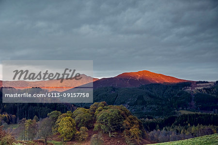 Sunlight illuminating tranquil mountaintops, Scotland