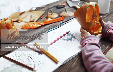 Creative girl carving Halloween pumpkins