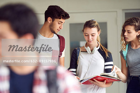 Students studying together in corridor