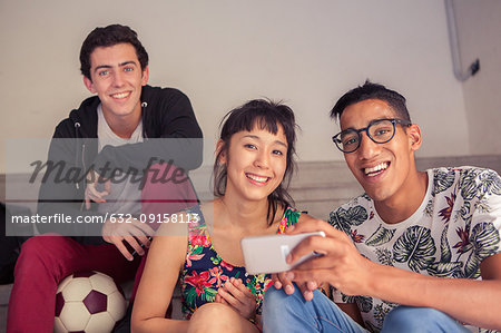 Friends hanging out and using smartphone together