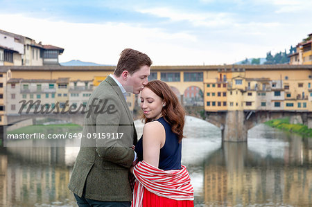 Young man kissing woman, Ponte Vecchio, the Old Bridge, Florence, Toscana, Italy