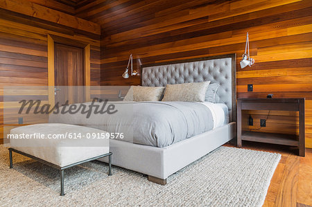 King size bed in master bedroom inside luxurious cedar wood home