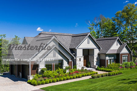 Contemporary natural stone and wood luxurious bungalow style home facade