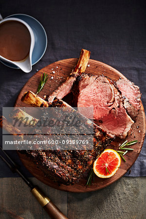 Citrus and rib roast on a wooden cutting board