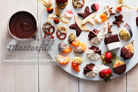 Cookies and sweets dipped in melted chocolate on a platter