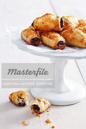 Mini pain au chocolat on a pedestal cake stand