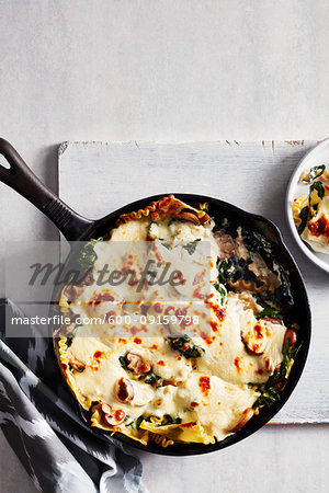 Mushroom and spinach lasagne in a cast iron skillet