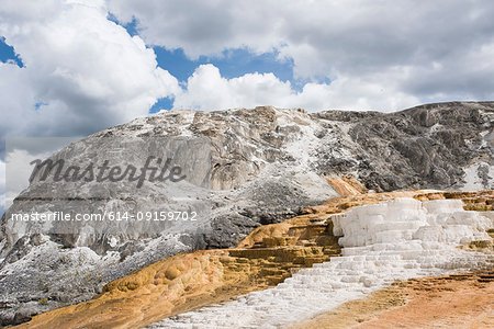 White mineral terraces on mountainside, Yellowstone National Park, Wyoming, USA