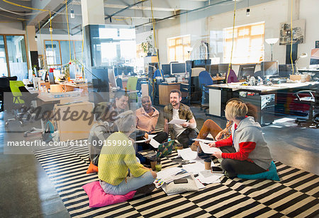 Creative business team meeting, brainstorming in circle on floor