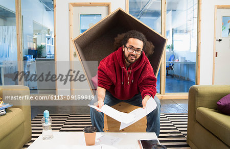 Portrait smiling, confident creative businessman working in office