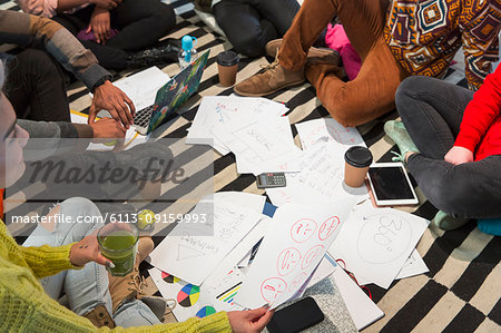 Creative business people meeting, brainstorming in circle on floor Creative business people meeting, brainstorming in circle on floor