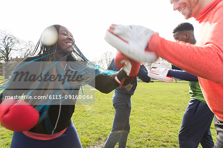 Smiling woman boxing in park