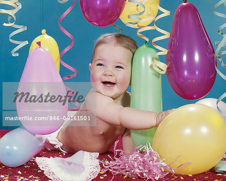 1960s BABY GIRL HUGGING BALLOON CONFETTI STREAMERS SMILING HAPPY