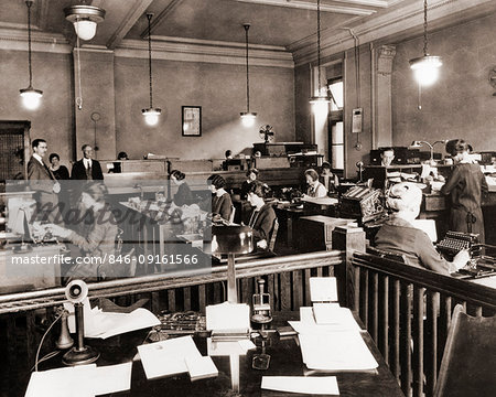 1910s 1920s BUSINESS OFFICE WITH WOMEN SITTING AT DESKS IN BULLPEN AREA