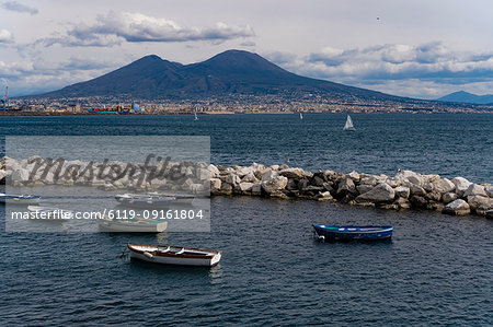 Day view of Mount Vesuvius, the active volcano, seen from the Gulf of Napoli with buildings ashore, Naples, Campania, Italy, Europe