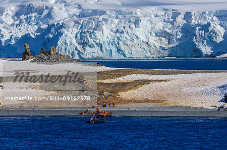 Expedition tourists leave Half Moon Island, Livingston Island blue glaciers and evening sun, South Shetland Islands, Antarctica, Polar Regions