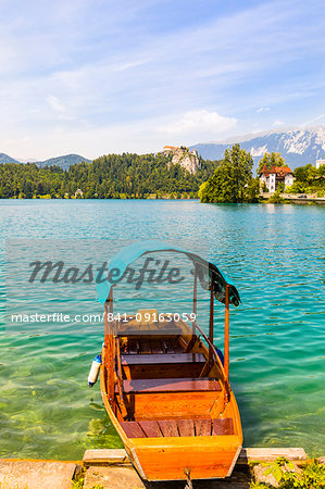A boat on Lake Bled with Bled Castle in the background, Lake Bled, Slovenia, Europe