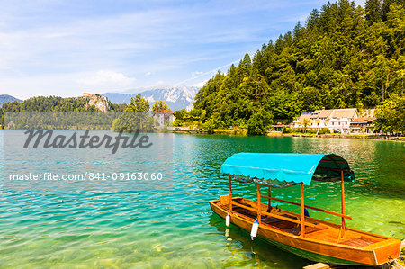 A boat on Lake Bled with Bled Castle in the background, Lake Bled, Slovenia, Europe