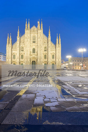 Milan Cathedral reflected in a puddle after a snowfall at twilight, Milan, Lombardy, Northern Italy, Italy, Europe Milan Cathedral reflected in a puddle after a snowfall at twilight, Milan, Lombardy, Northern Italy, Italy, Europe