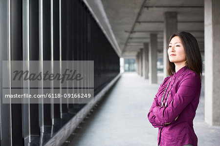 An Asian female business owner in a new raw business space.