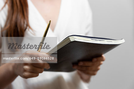 Woman with notepad and pencil