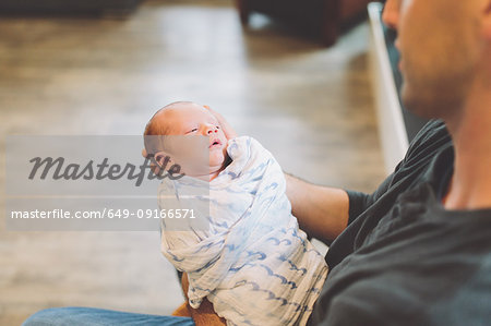 Father holding newborn baby boy