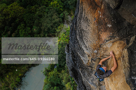 Man rock climbing Guilin Sugarloaf, high angle view, Yangshuo, Guangxi, China