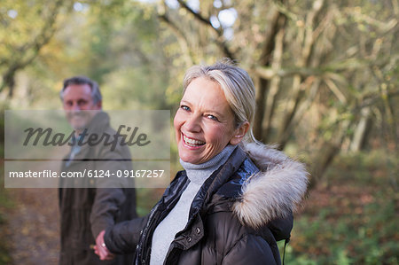 Portrait smiling, happy mature couple holding hands in park