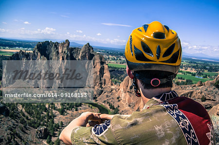 Rock climber looking away at rock formation, Smith Rock State Park, Terrebonne, Oregon, United States