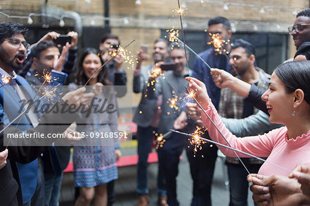 Friends celebrating with sparklers at party