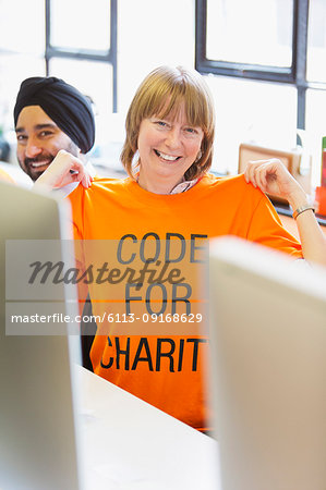 Portrait confident hacker wearing t-shirt, coding for charity at hackathon